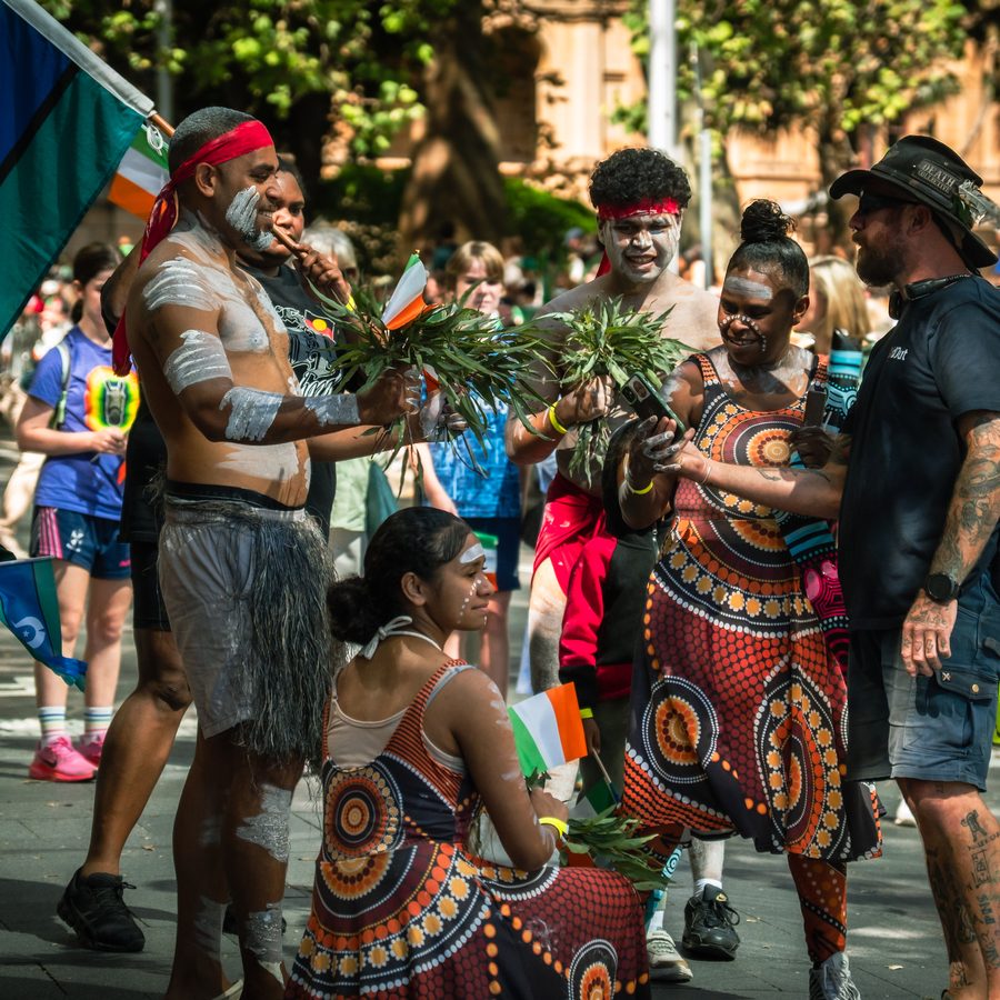 Performers gathered with flags before a city procession