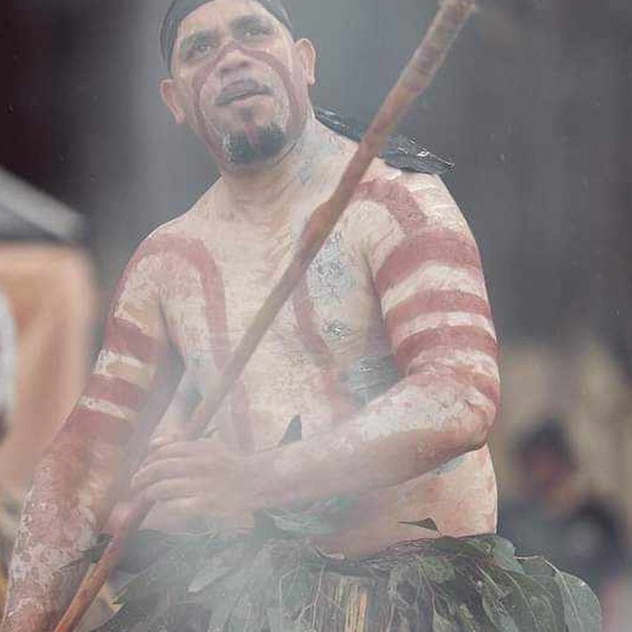 Ryka Ali holding a spear, framed by ceremony smoke